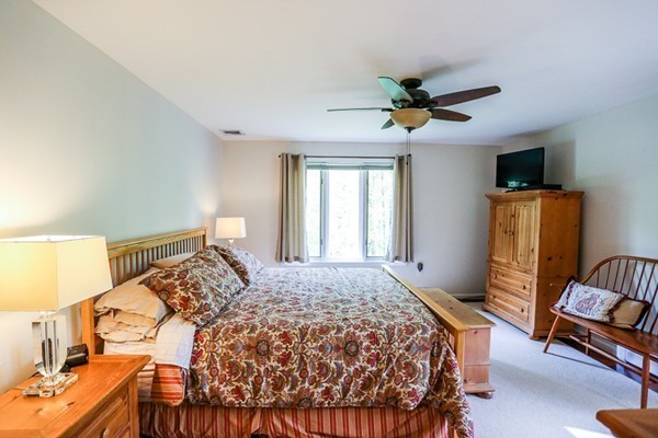 18 Saddle Hill Road Boxford, MA 01921 - Photo 16 of 20 a bedroom with a bed and wooden floor