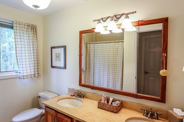 18 Saddle Hill Road Boxford, MA 01921 - Photo 17 of 20 a bathroom with a sink vanity mirror and toilet