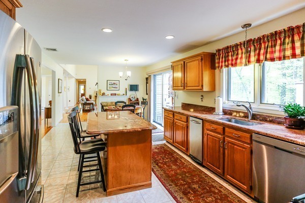 18 Saddle Hill Road Boxford, MA 01921 - Photo 6 of 20 a kitchen with stainless steel appliances granite countertop a refrigerator a sink dishwasher a stove and white countertops with wooden floor