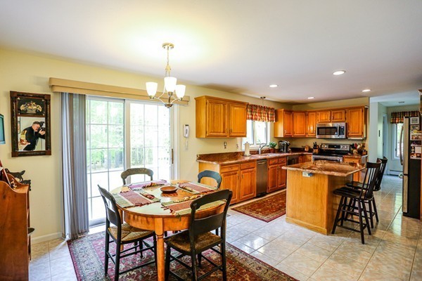 18 Saddle Hill Road Boxford, MA 01921 - Photo 7 of 20 a dining room filled counter top space and a dining table with kitchen view