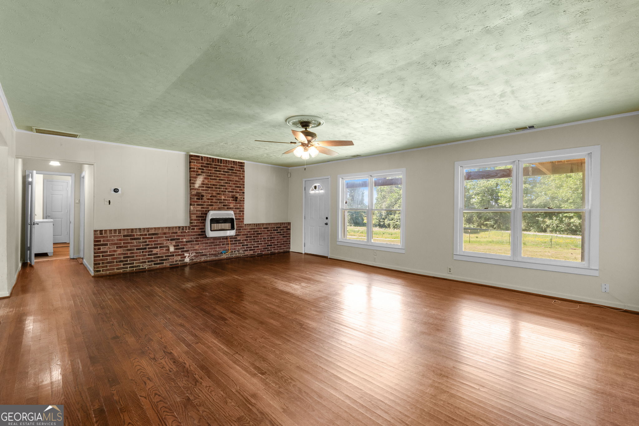 49 Frost Road Bowdon, GA 30108 - Photo 9 of 60 a view of a livingroom with wooden floor and a large window