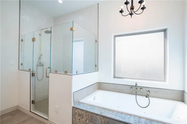 a bathroom with a granite countertop sink a mirror and shower