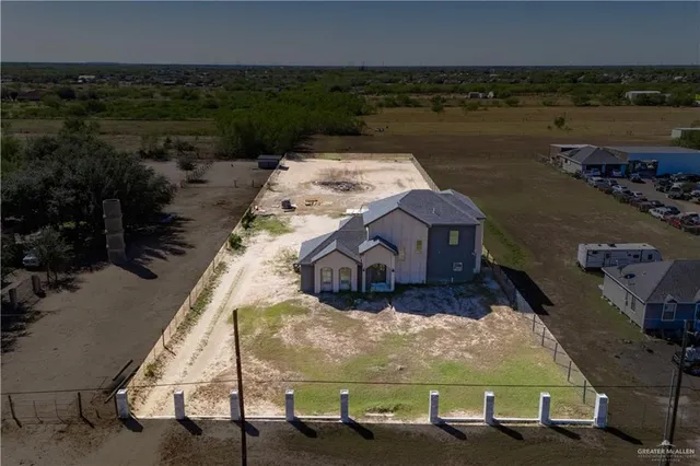 an aerial view of a house with outdoor space