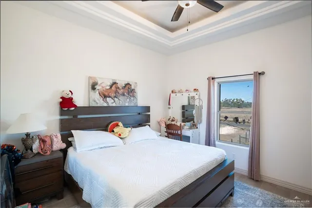 a bedroom with a bed and a painting on the wall