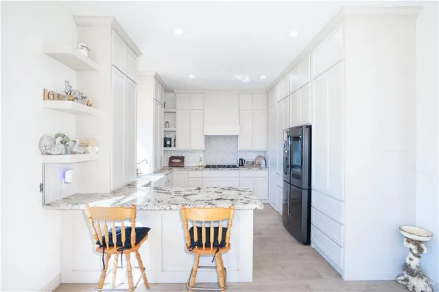a kitchen with a sink stove and white cabinets