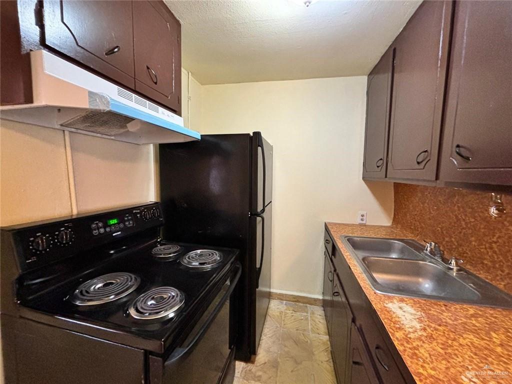 518 West U.S. Highway 83, Unit 3 Pharr, TX 78577 - Photo 3 of 5 a kitchen with a sink a stove and refrigerator