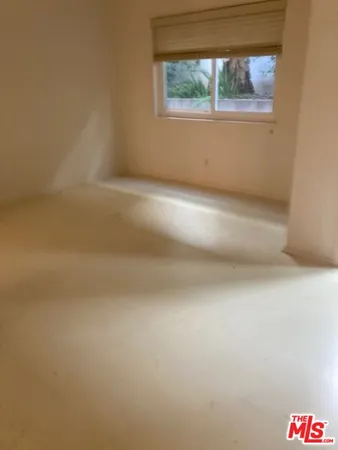 a view of an empty room and a window