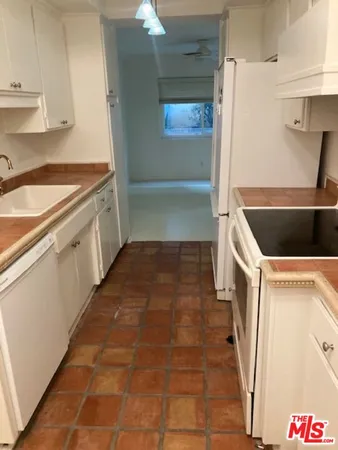 a kitchen with a cabinets and a stove top oven