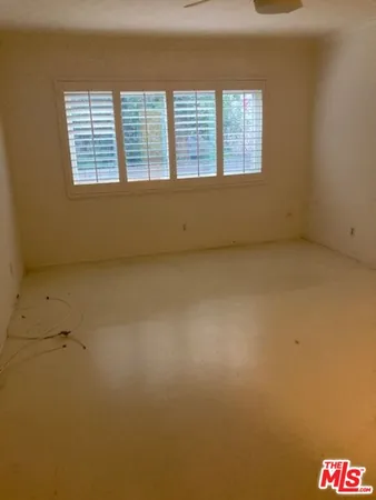 an empty room with a empty space and windows