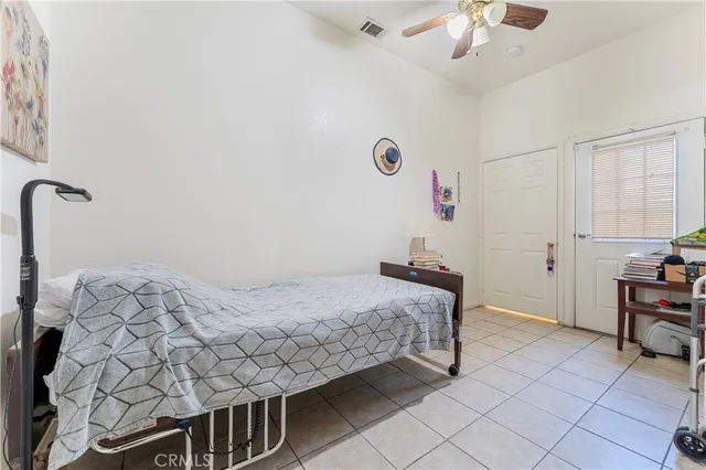 a bedroom with bed and a chandelier