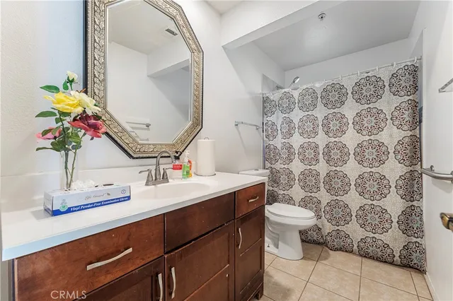 a bathroom with a sink toilet and mirror