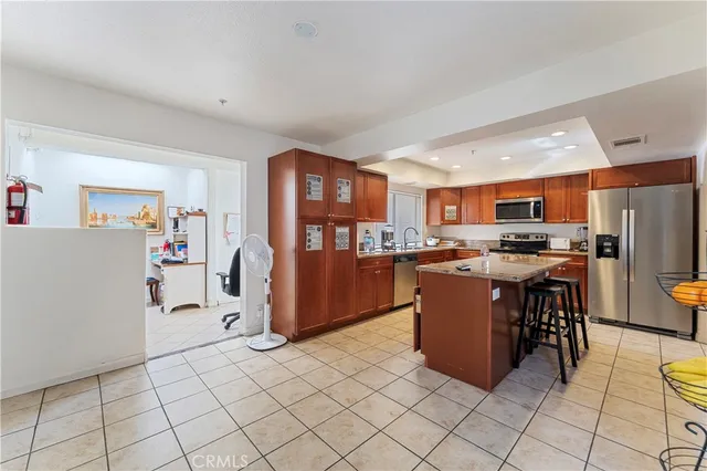 a kitchen with stainless steel appliances a refrigerator and a stove top oven