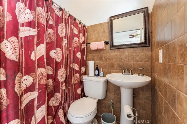 a bathroom with a sink and mirror with toilet