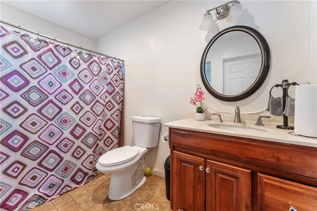 a bathroom with a toilet a sink and a mirror