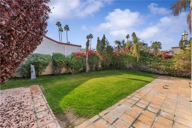 a view of a garden with a building in the background