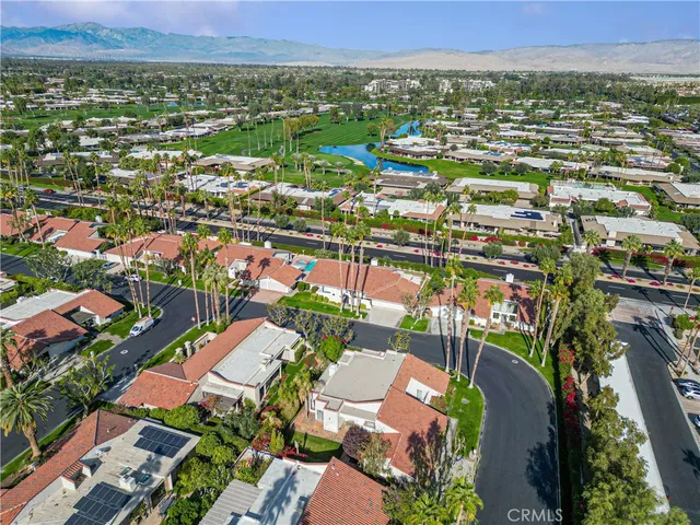an aerial view of residential houses with outdoor space and street view