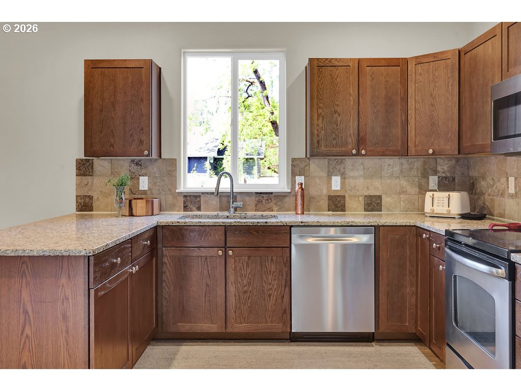 654 North Garden Way Eugene, OR 97401 - Photo 14 of 47 a kitchen with a sink stove and cabinets