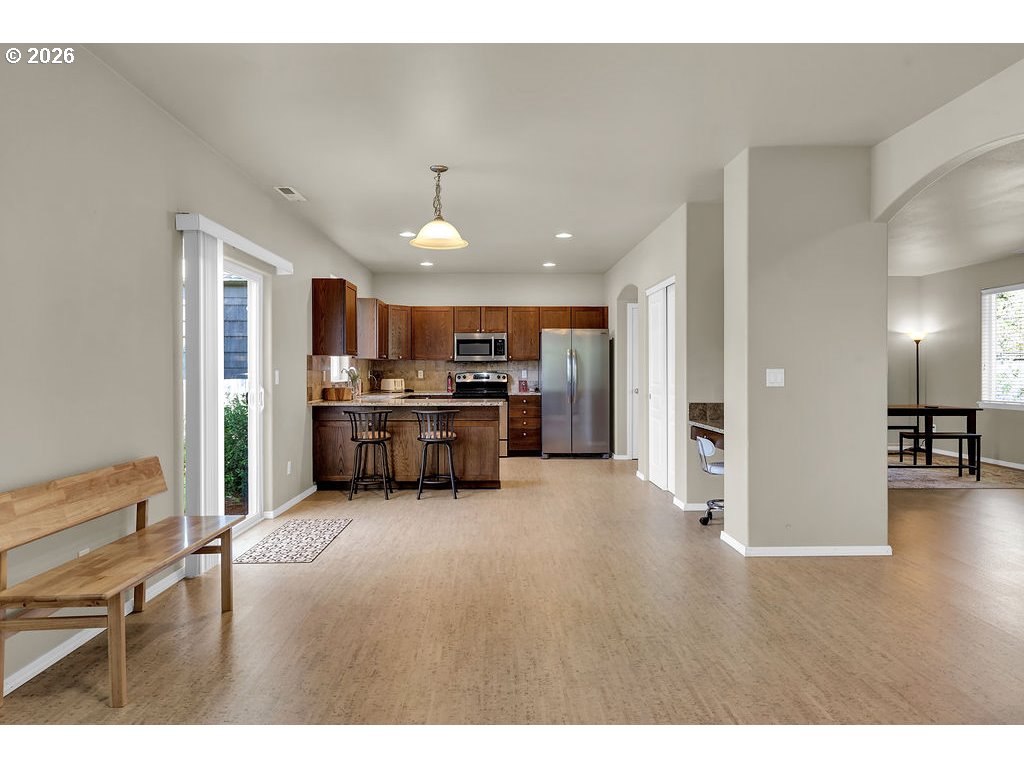 654 North Garden Way Eugene, OR 97401 - Photo 20 of 47 a living room with furniture and kitchen view
