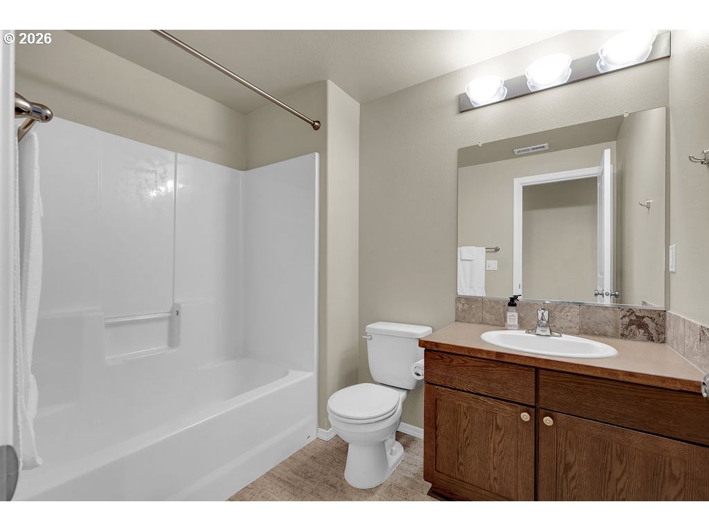 654 North Garden Way Eugene, OR 97401 - Photo 27 of 47 a bathroom with a sink a toilet and a mirror