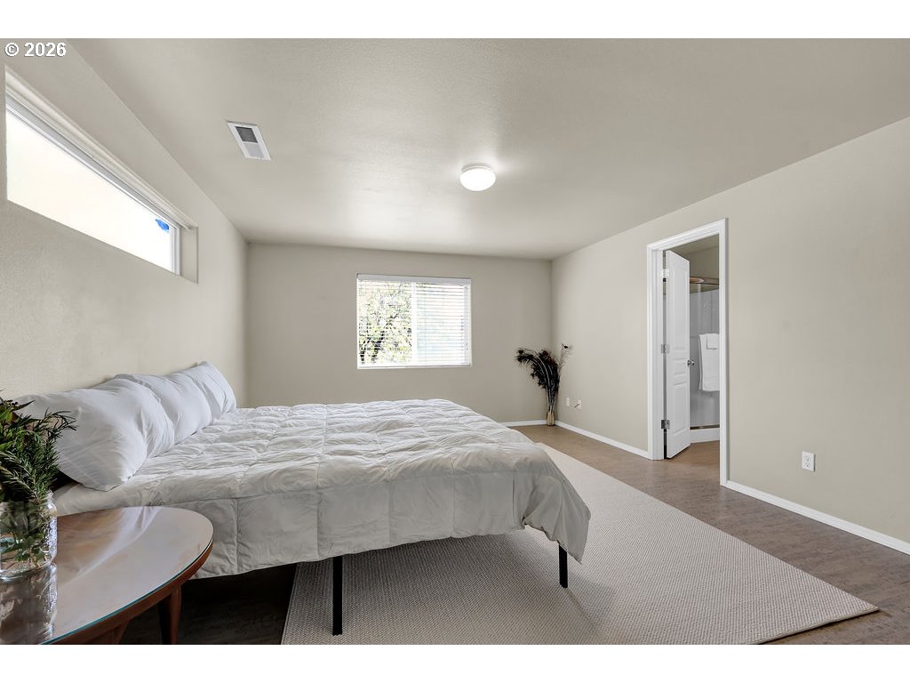 654 North Garden Way Eugene, OR 97401 - Photo 32 of 47 a bedroom with a bed and a window