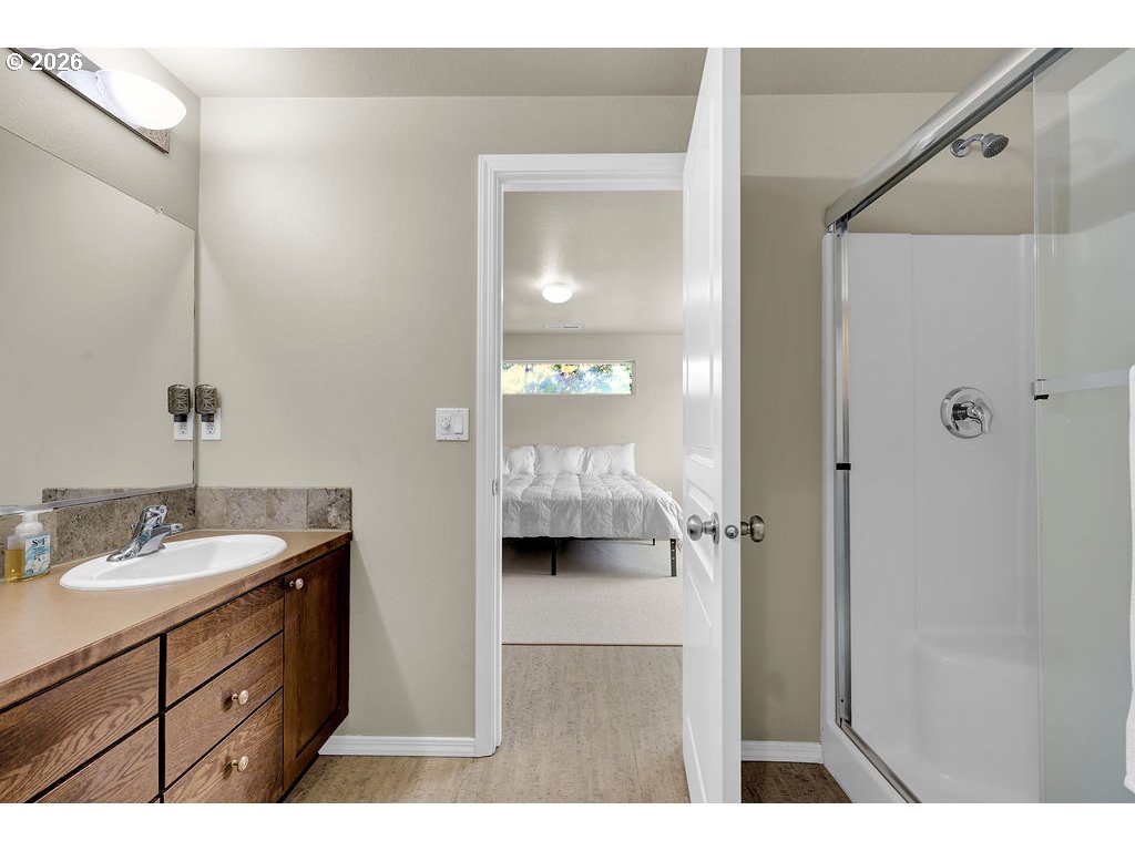 654 North Garden Way Eugene, OR 97401 - Photo 37 of 47 a bathroom with a double vanity sink and mirror