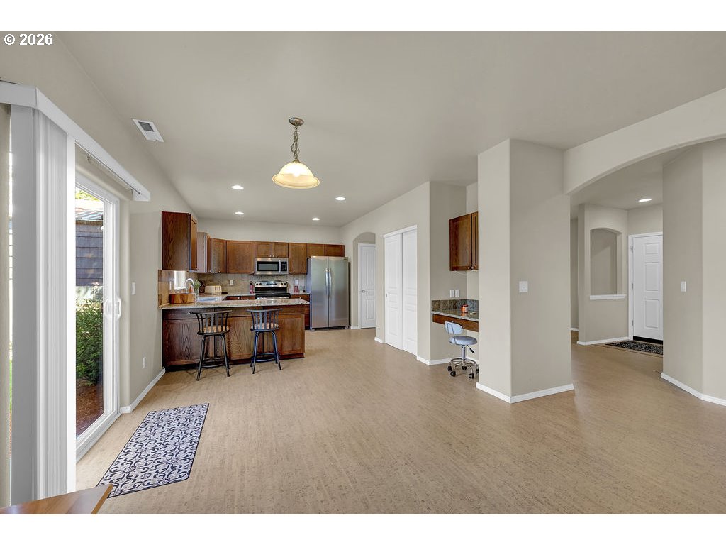 654 North Garden Way Eugene, OR 97401 - Photo 9 of 47 a open kitchen with a refrigerator and a stove