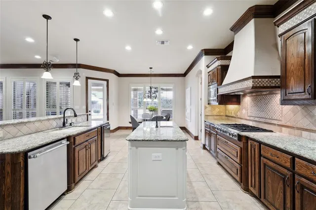 a kitchen with granite countertop stainless steel appliances and counter space