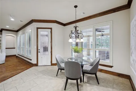a spacious bedroom with a large bed and a chandelier