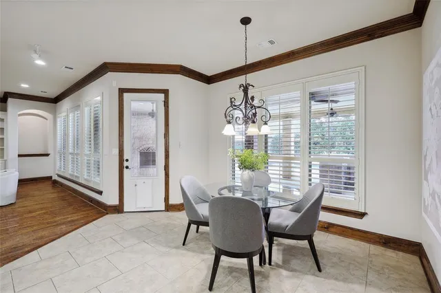 a spacious bedroom with a large bed and a chandelier