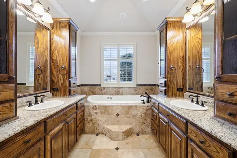 a large bathroom with a granite countertop sink a toilet and a bathtub