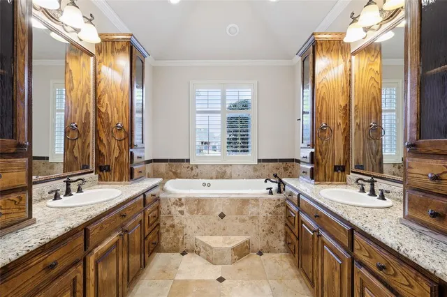 a large bathroom with a granite countertop sink a toilet and a bathtub