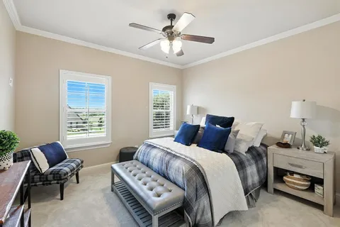a living room with furniture and a ceiling fan