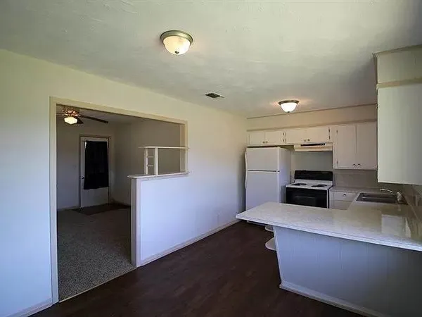 a kitchen with sink and cabinets