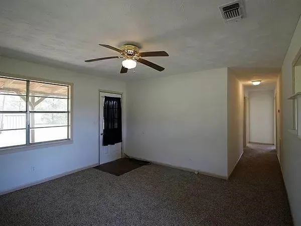 a view of empty room with ceiling fan