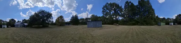 a view of a trees with a house in the background