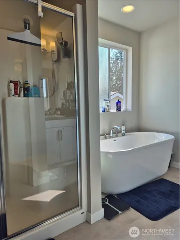 a bathroom with a bathtub and shower