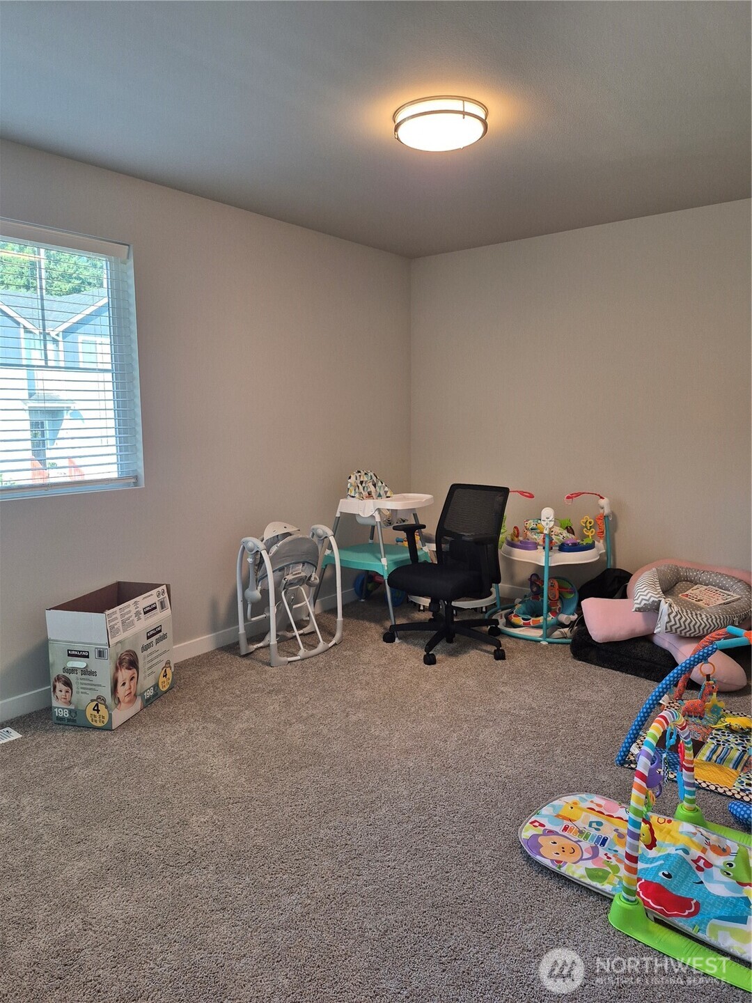 9204 Mint Loop Northwest Bremerton, WA 98311 - Photo 22 of 26 a room with a baby bed a couch and a window