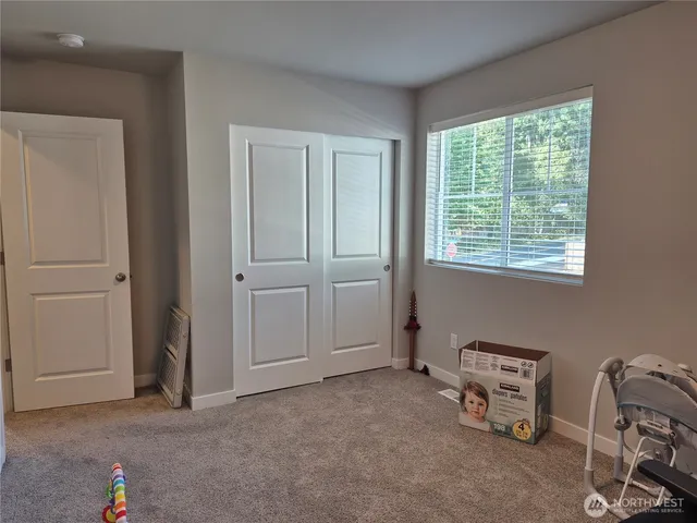 an empty room with windows and closet
