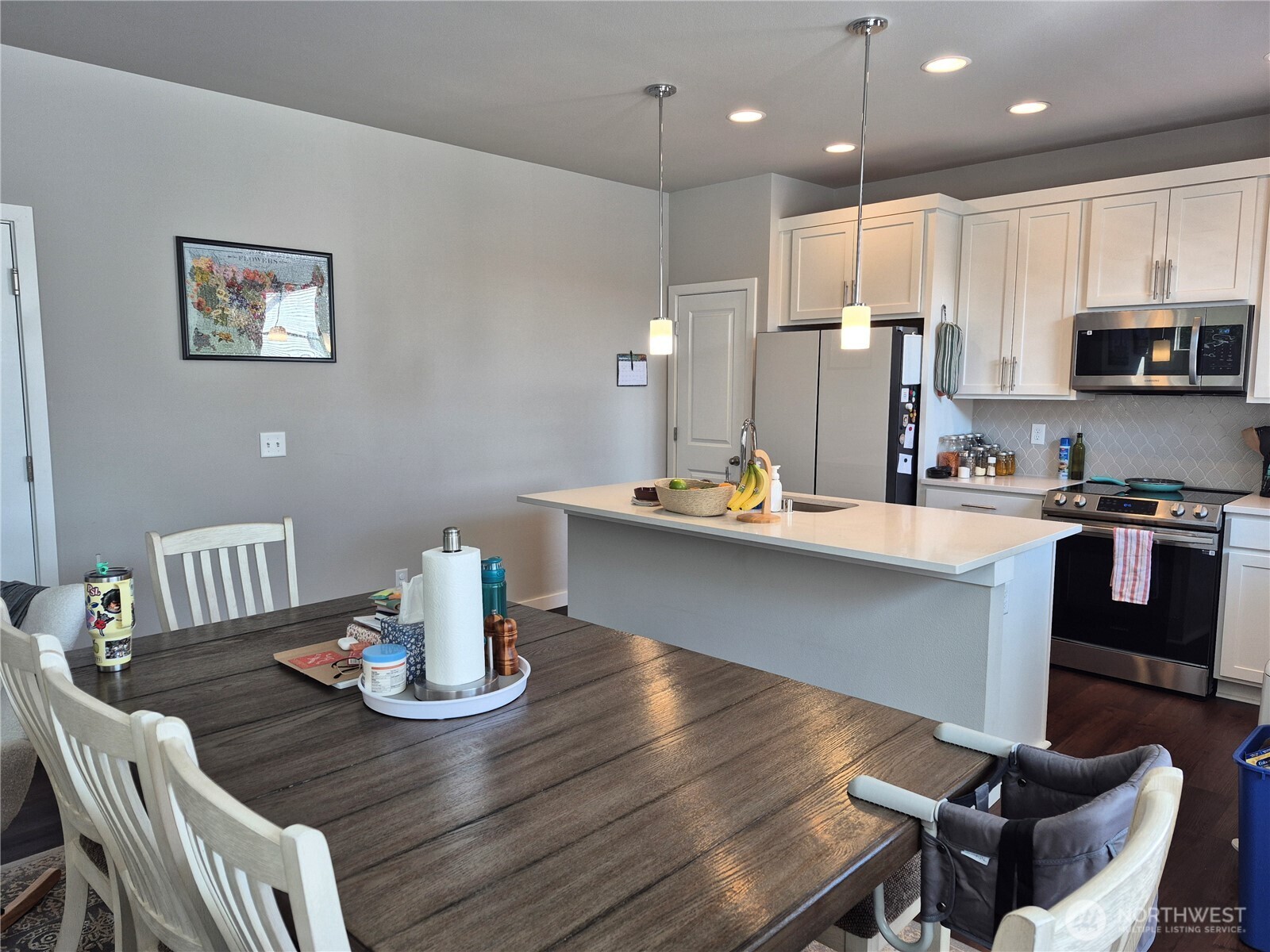 9204 Mint Loop Northwest Bremerton, WA 98311 - Photo 6 of 26 a kitchen with a dining table chairs and kitchen view