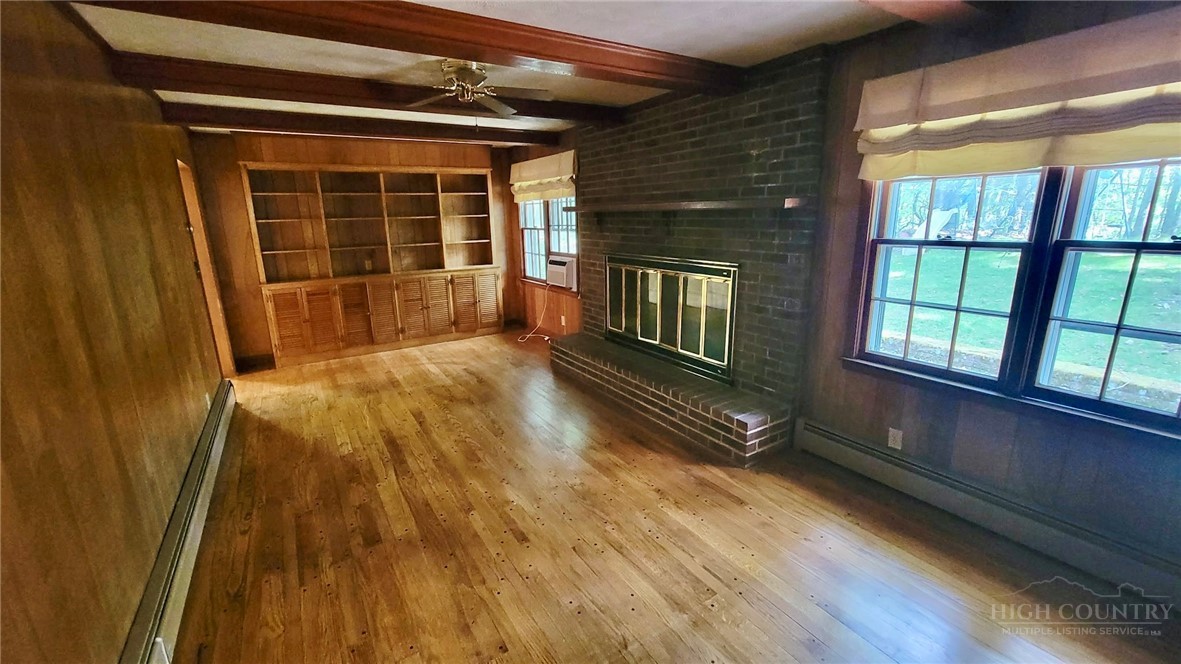 247 Crest Drive Boone, NC 28607 - Photo 4 of 19 a view of an empty room with wooden floor and a window