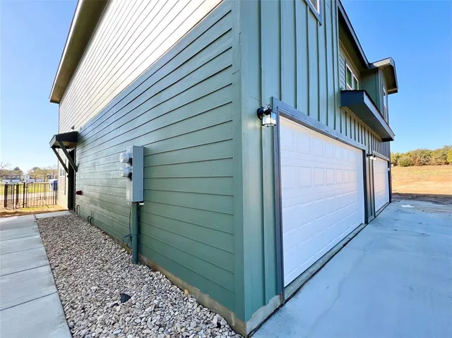 a view of a house with a wooden fence