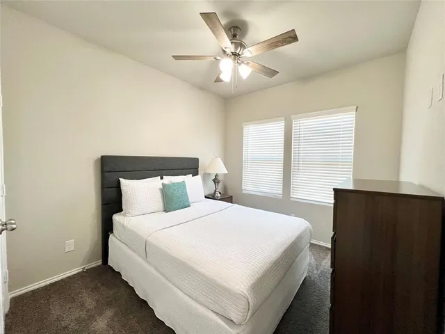 a bedroom with a large bed and a large window
