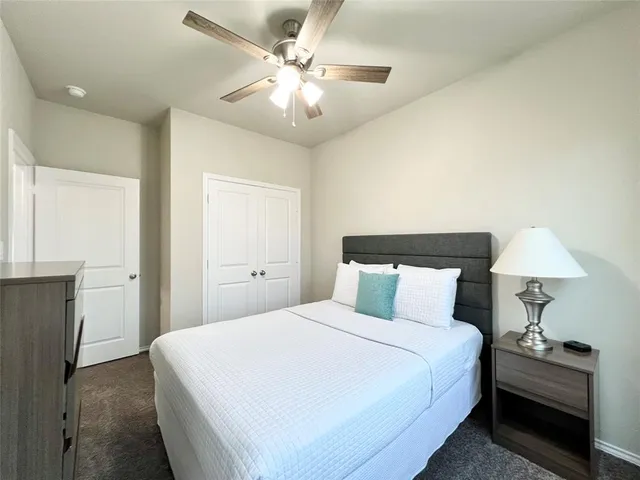 a bedroom with a bed and a lamp