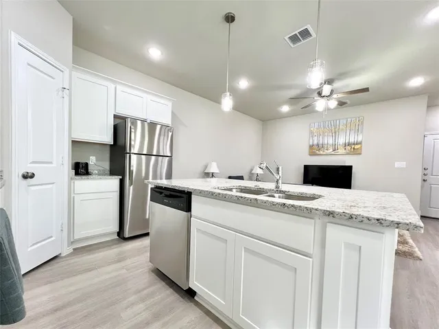 a large kitchen with a table and chairs