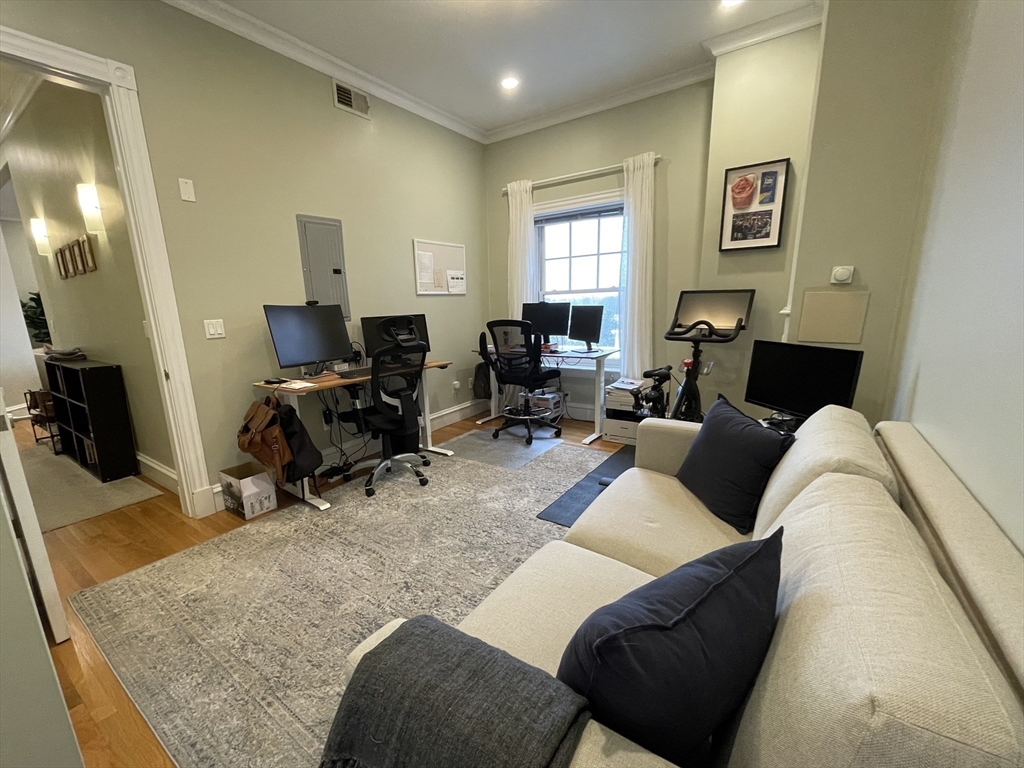55 Magazine Street, Unit 64 Cambridge, MA 02139 - Photo 12 of 23 a living room with furniture and a wooden floor