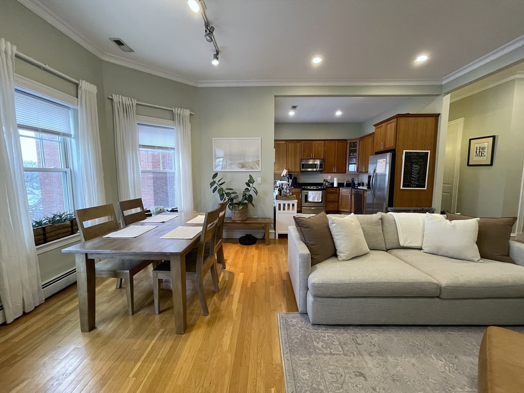 55 Magazine Street, Unit 64 Cambridge, MA 02139 - Photo 2 of 23 a living room with furniture kitchen view and a wooden floor