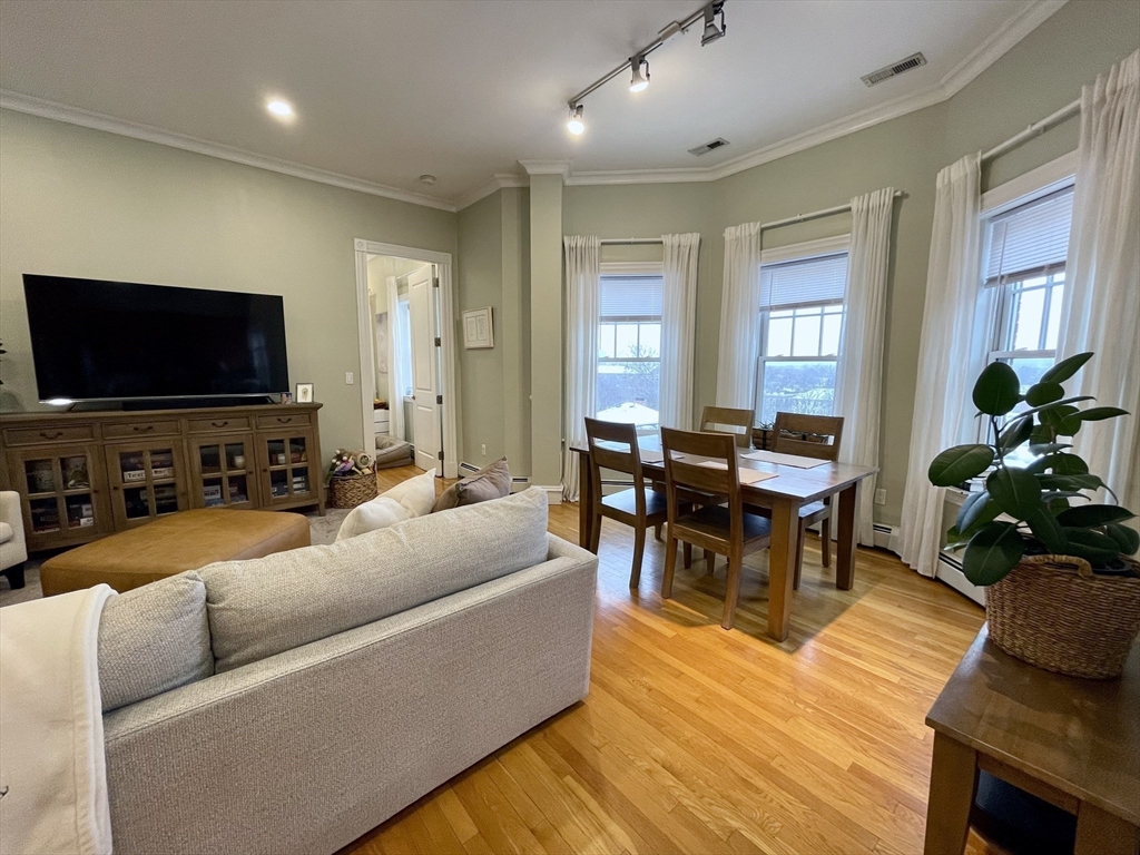55 Magazine Street, Unit 64 Cambridge, MA 02139 - Photo 5 of 23 a living room with furniture and a flat screen tv