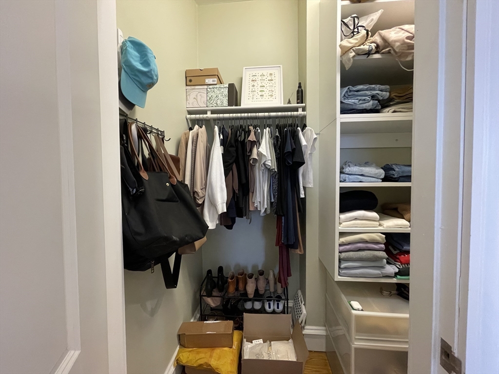 55 Magazine Street, Unit 64 Cambridge, MA 02139 - Photo 8 of 23 a view of walk in closet with clothes and shoes