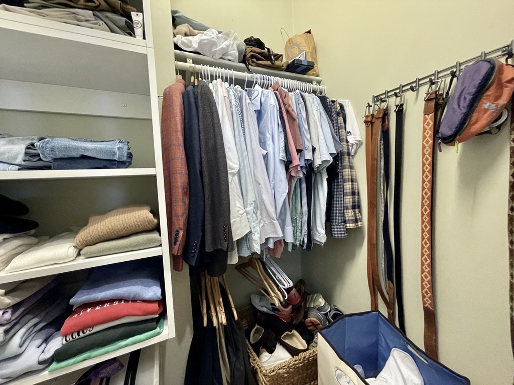 55 Magazine Street, Unit 64 Cambridge, MA 02139 - Photo 9 of 23 a view of walk in closet with clothes and shoes