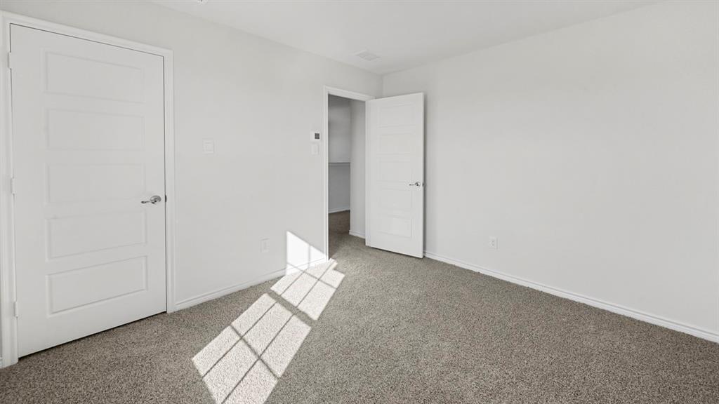 412 Carthage Street Caddo Mills, TX 75135 - Photo 13 of 32 Room featuring light gray carpet flooring and white walls